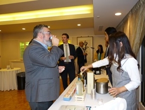 Attendee listening to an explanation on Shochu & Awamori at a Japanese food trading company's booth